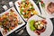 Food. Salads from vegetables, salmon, veal, steak, meat. On a wooden background. Top view.