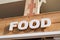 Food sign text on restaurant in a city street storefront building