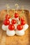 Food snacks and appetizers for buffet. Canapes with mozzarella cheese and cherry tomatoes served on wooden tray