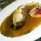 Food specialty Polish style duck with apples as photographed in