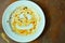 Food stain with smiling face on white dish