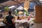 A food stall owner waits for customers at his taco stall at a busy market