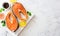 Food stone background with raw salmon steaks  sea salt  peppers and lemon