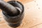 Food stone mortar and pestle on wooden background