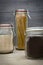 Food storage. Food ingredients in glass jars, on wood background.