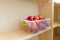 Food storage, wooden shelves in the pantry with apple containers