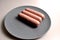 Food - three sausages on a gray plate