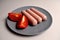 Food - three sausages on a gray plate