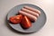 Food - three sausages on a gray plate