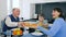 Food time, grandmother brought delicious bakery products on plate for boy and granddad sitting at desk