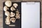 Food. Top view mushrooms on a black cutting board. To cook the champignon. Write down the recipe. Copy space, clear space. Tablet