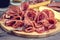 Food Tray With Delicious Salami Pieces of Sliced Ham and Crackers and Bread Sticks Meat Plate Toned