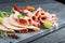 Food tray with delicious salami, pieces of sliced ham, sausage, tomatoes, salad and vegetable - Meat platter with selection