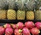 Food vendor display of pineapples and dragonfruit