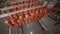 Food warehouse. Worker putting sausages on a rack in a food factory warehouse.