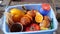 Food waste at household, Peels of oranges. A woman throws uneaten rotten fruit and juice fruit waste into the trash can