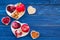 Food which help heart stay healthy. Vegetables, fruits, nuts in heart shaped bowl on blue wooden background top view