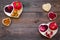 Food which help heart stay healthy. Vegetables, fruits, nuts in heart shaped bowl on dark wooden background top view