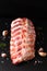 Foos concept organic raw pork ribs on black slate board with copy space