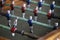 Foosball. Soccer hall game. Traditional game. Soccer game. Table with soccer players. Old wooden foosball. Football players. Dolls