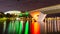 A Foot Bridge crossing a river and Sports Stadium at Night