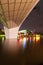 A Foot Bridge crossing a river and Sports Stadium at Night