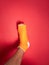 Foot with broken toe bone in orange fiberglass cast pink background. Injured fractured swollen male leg. Patient body