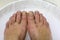 foot care. feet in foamy water