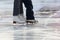 Foot ice-skating little girl with my mom at the rink