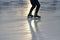 Foot ice-skating person on the rink in the sunlight