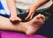 Foot and leg massage,  Therapist pouring oil to a foot about to massage