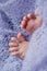 Foot little fingers of a newborn on lilac background