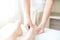 Foot massage. Close up of hands therapist`s massaging female foot. Asian woman in wellness beauty spa having aroma therapy massag