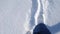 foot movement in the snow. a man walking in the snow top view