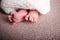 Foot newborn baby girl posing