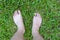 Foot over green grass