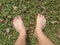 Foot over green grass