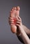 Foot pain in arch. Woman holding leg with red point closeup. Plantar fasciitis, inflammation, injuries, overuse. Health