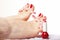 Foot pedicure applying red toenails on white