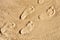 Foot prints in the sand. The concept of travel and vacation by the sea. Foot disease, orthopedic problems, flat feet