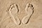 Foot prints in the sand. The concept of travel and vacation by the sea. Foot disease, orthopedic problems, flat feet