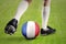 Foot of soccer player play ball with a France flag