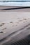 Foot steps in the sand on a deserted beach