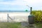 Foot washing and shower on the beach under the palm tree in front of the sea. Look ahead to the sea. Can be use as background of a