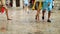 Foot of young couple walking the old city during a holiday on a rainy day on the seaside.