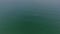 Footage of bluish green ocean with simulated flashes