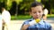 Footage boy eating boiled corn in a park close-up. 4k