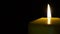 Footage burning candle isolated on black