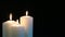 Footage burning candles isolated on a black background.