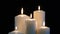 Footage burning candles isolated on a black background.